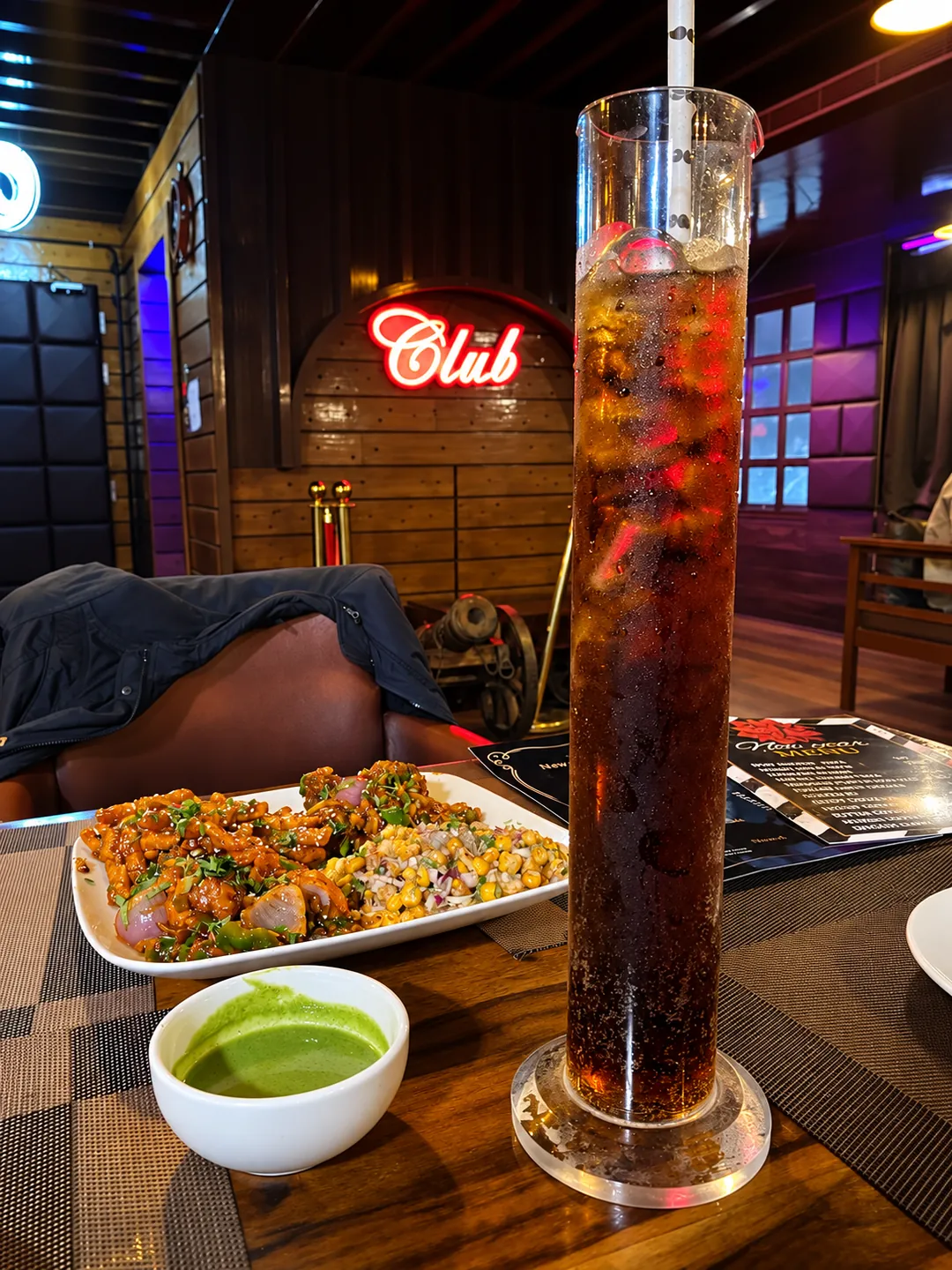 A tall iced drink with bar snacks at BAR CODE bar and restaurant in Civil Lines, Prayagraj.